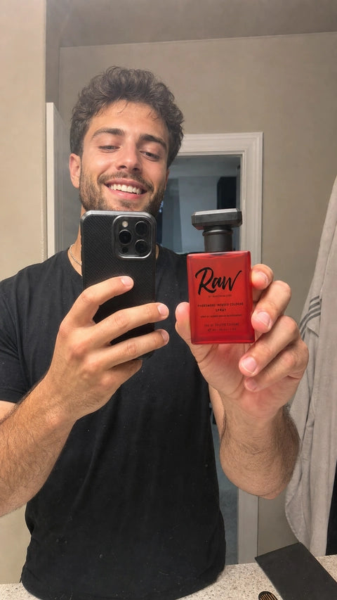 RAW customer filming a casual bathroom mirror review while holding the bottle