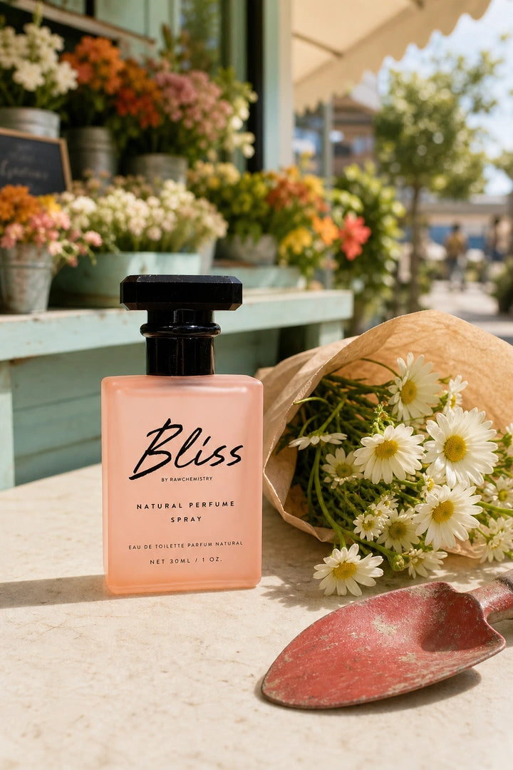 Bliss perfume and carton in a bright, playful vanity scene