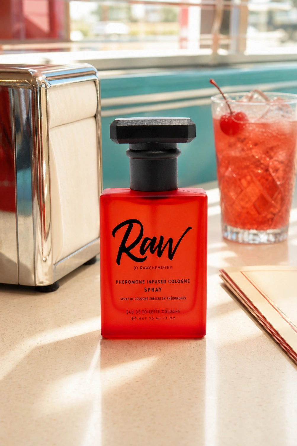 RAW cologne and carton on a bright dresser beside everyday essentials