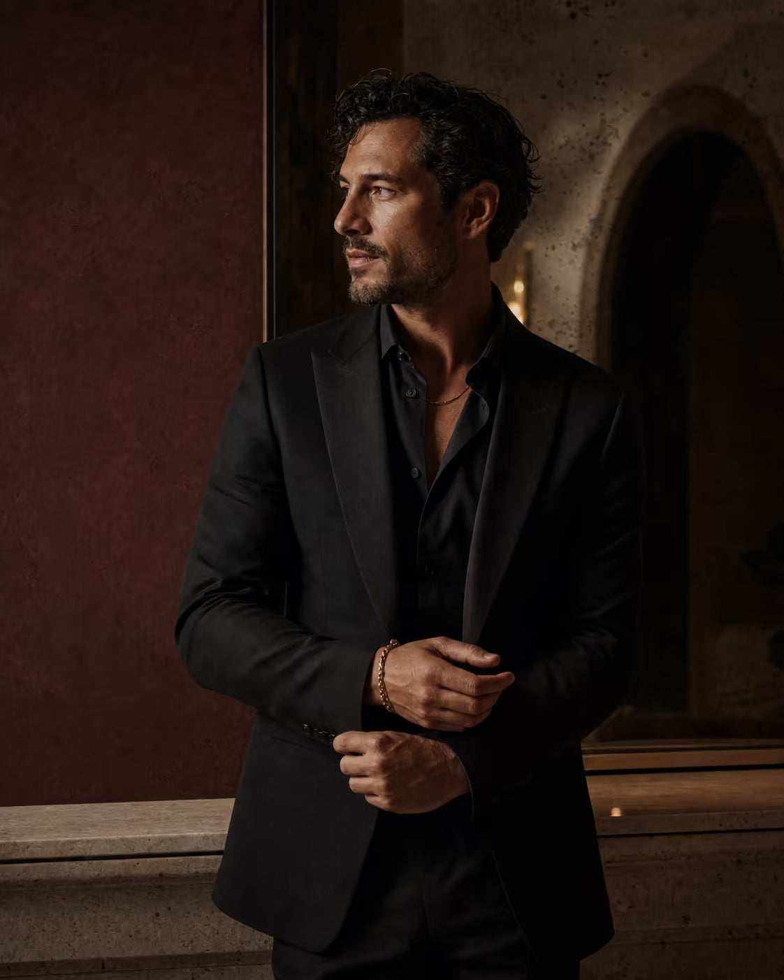 Man getting ready in a tailored black jacket
