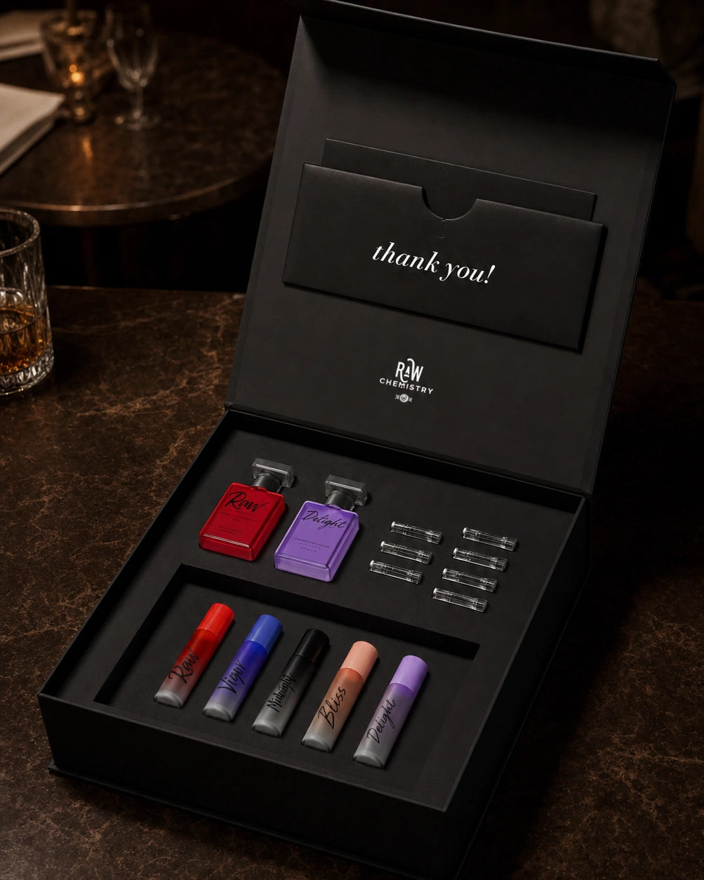 Open RAW Chemistry Discovery Collection box with two miniature fragrances, five roll-ons, and seven sample vials