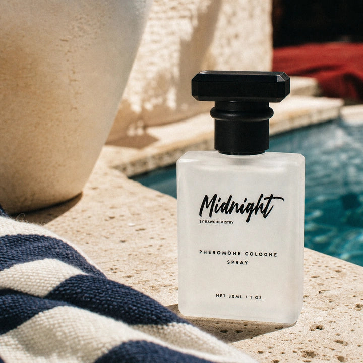Midnight pheromone cologne photographed beside a Mediterranean pool