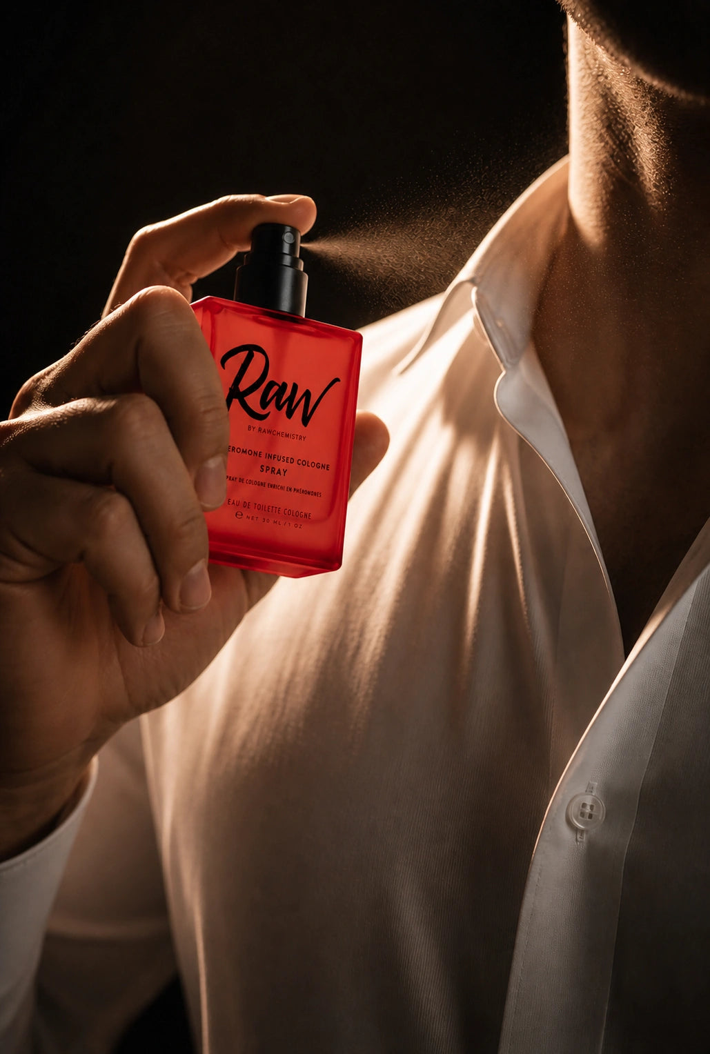 A man applying RAW pheromone-infused cologne before going out
